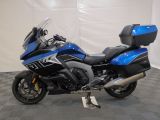 a picture of a blue and black motorcycle parked on a checkered floor