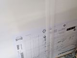 a picture of a refrigerator that is in the corner of a room