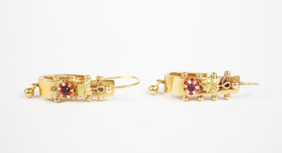 two pairs of gold earrings with garnets on them