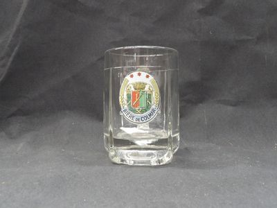 a shot of a glass with a crest on it