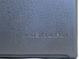 an image of a black wallet with the words made in japan written on it