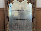 a large mirror sitting on a wooden floor in a room