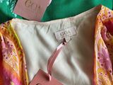 a close up of three different colored shirts with tags on them