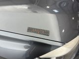 a close up of a car ' s tail light with a sticker on it