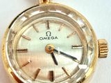 an image of a close up of a gold watch on a white surface