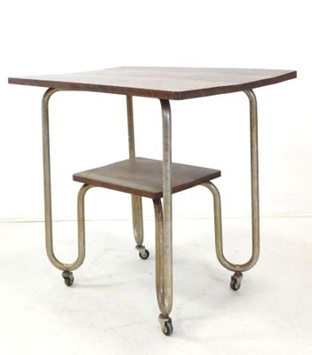 a small table with a stool on wheels on a white floor