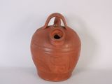 a brown vase with a handle on a white surface