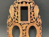 a wooden clock with two mirrors on it