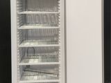 an image of a white refrigerator sitting in a room next to a black wall