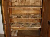 a wooden cabinet with a mirror on top of it