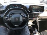 someone is sitting in the driver ' s seat of a car with their feet on the steering wheel