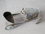 a small toy car made out of metal on a table