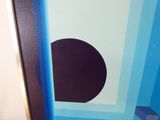 a picture of a picture of a black circle on a blue and white background