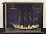 a picture of a model of a ship in a glass case