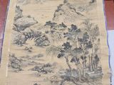 an old scroll with a painting of a mountain scene on it