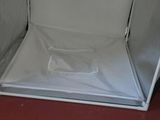 a silver box with a white cloth inside of it