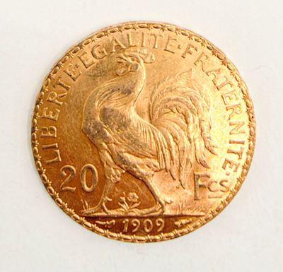 a gold coin with a rooster on it on a white surface