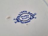 a blue and white plate that has a blue and white design on it