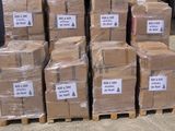 several stacks of cardboard boxes are stacked on pallets in a warehouse