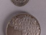 a silver coin with a picture of a coat of arms on it
