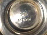 a close up of a silver plate on a table