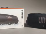 an image of a black speaker sitting next to a box