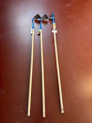 two brooms are sitting on a table next to each other