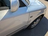 a silver car that is parked on the side of the road