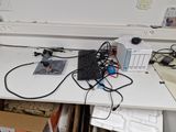 a computer desk with a keyboard, mouse, and other electronics on it