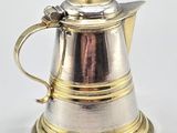 an image of a silver coffee pot with a gold handle on a white background