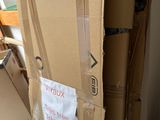 a cardboard box with a sign on it sitting on the floor