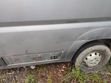 a van that has a flat tire on the side of the road