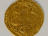 a close up of a gold coin on a white surface