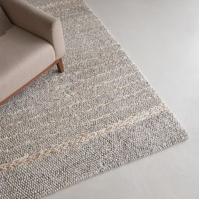 an image of a living room with a couch and a rug