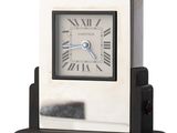 a small clock with roman numerals on it