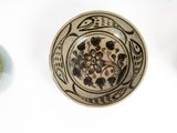 three bowls that have different designs on them