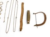 many different types of necklaces and bracelets laid out on a white surface