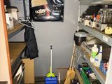 an image of a kitchen with a lot of clutter on the shelves