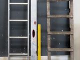 two ladders that are leaning against a wall
