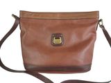 the brown leather bag has a metal clasp on it