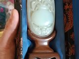 une personne tenant une boîte contenant un objet sculpté