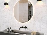 une salle de bains équipée d'un lavabo, d'un miroir et d'un tabouret