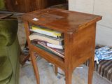 a small wooden table with a book on top of it