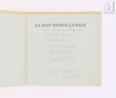 an open book with writing on it on a white surface