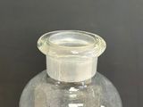 a clear glass vase with a clear lid on a table