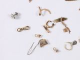 many different types of jewelry on a white surface