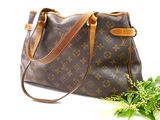 an image of a louis vuitton handbag and a plant