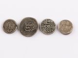 four different types of arabic coins on a white surface