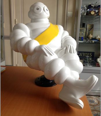 a statue of a man sitting on top of a table