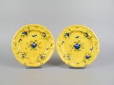 pair of yellow plates with blue flowers and leaves on them